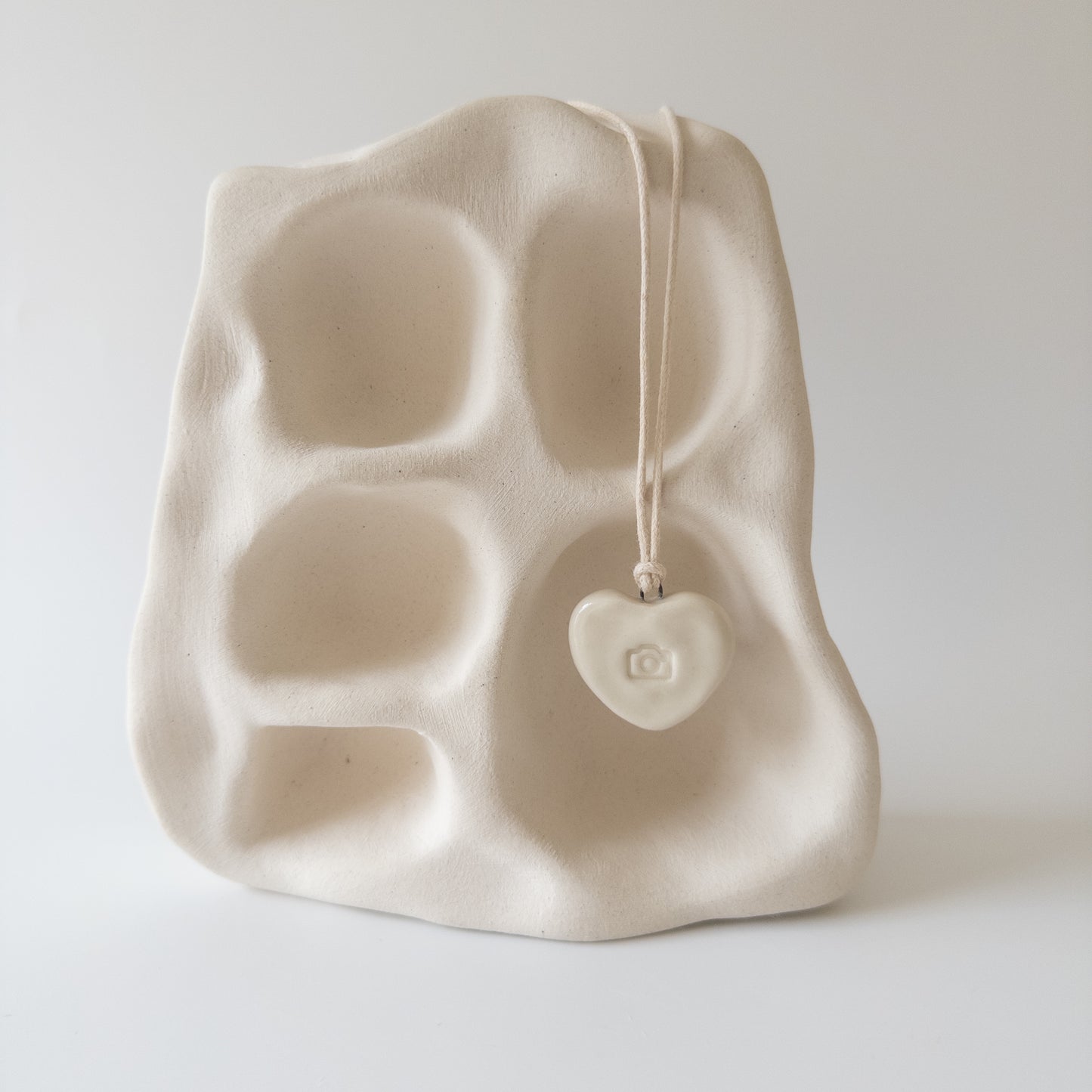 Ceramic pendant Heart with a camera