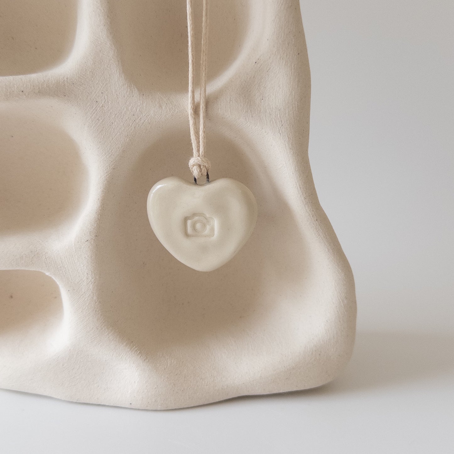 Ceramic pendant Heart with a camera