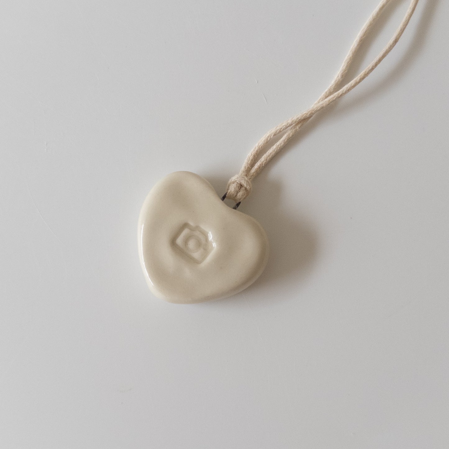 Ceramic pendant Heart with a camera