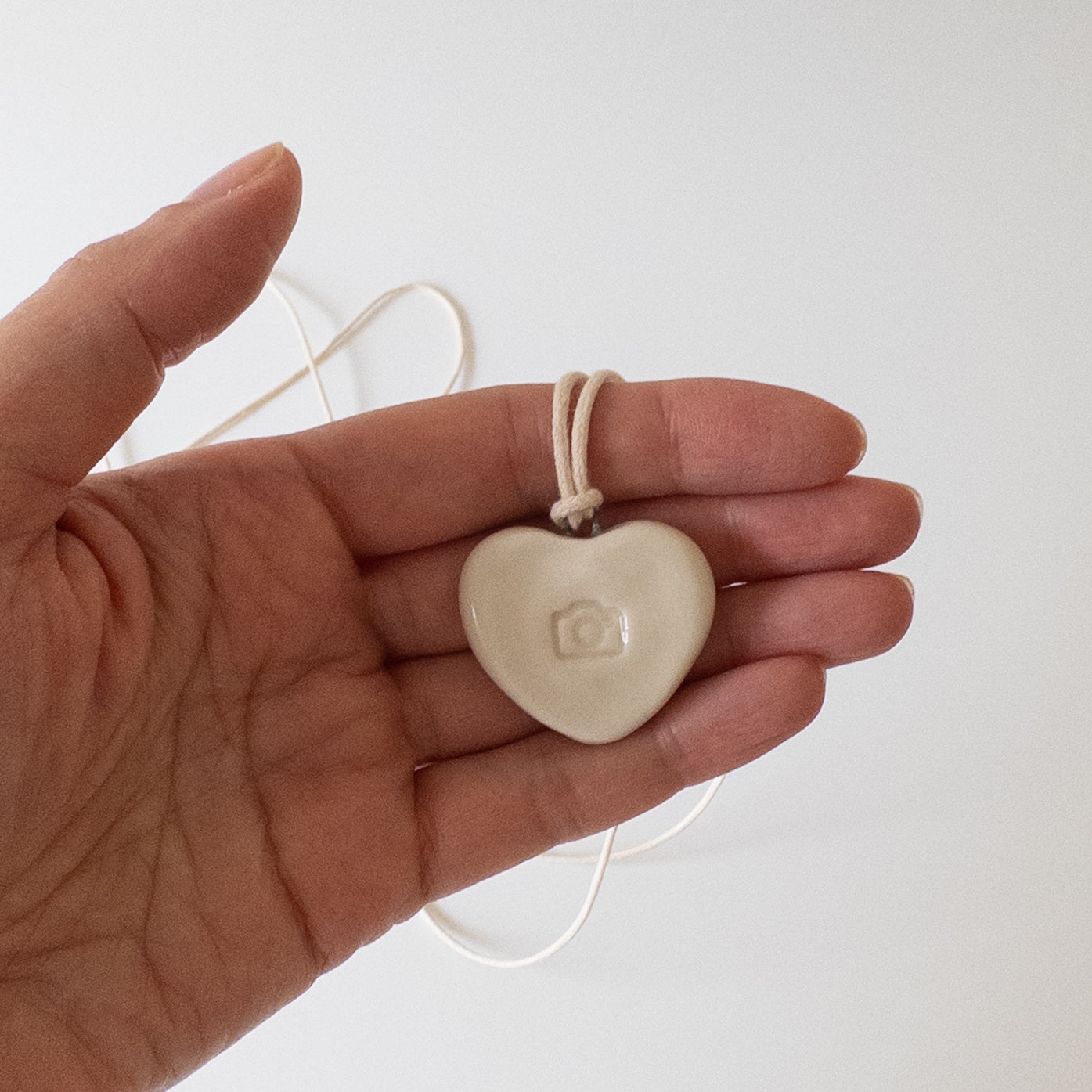 Ceramic pendant Heart with a camera